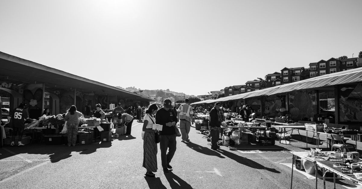 Black and white scene of Alemany Flea Market with shoppers and stalls in San Francisco.